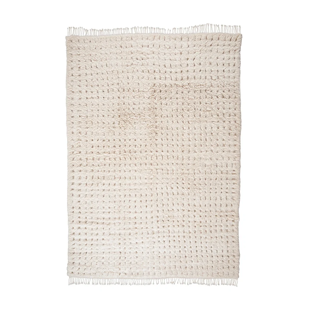 A rectangular, cream-colored hand-knotted rug with a textured pattern and short fringe on the shorter edges, displayed on a white background.