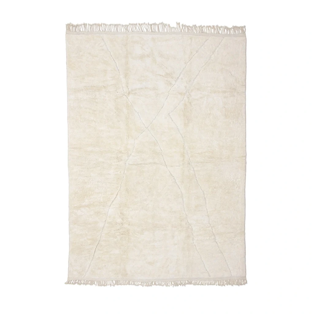 A rectangular cream-colored rug with subtle geometric lines and fringe on both shorter ends, displayed flat on a white background.