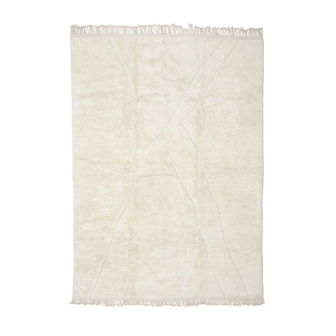 A rectangular cream-colored rug with subtle geometric lines and fringe on both shorter ends, displayed flat on a white background.
