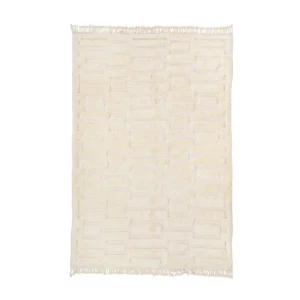 Cream-colored rectangular rug with a brick-like textured pattern and short fringe on two edges, viewed from above against a white background.