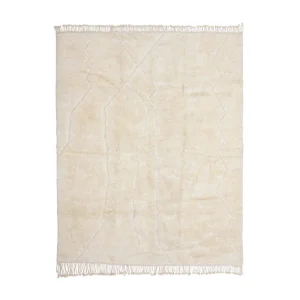 A rectangular, cream-colored shaggy rug with subtle geometric line patterns and fringes along the shorter edges, photographed on a white background.