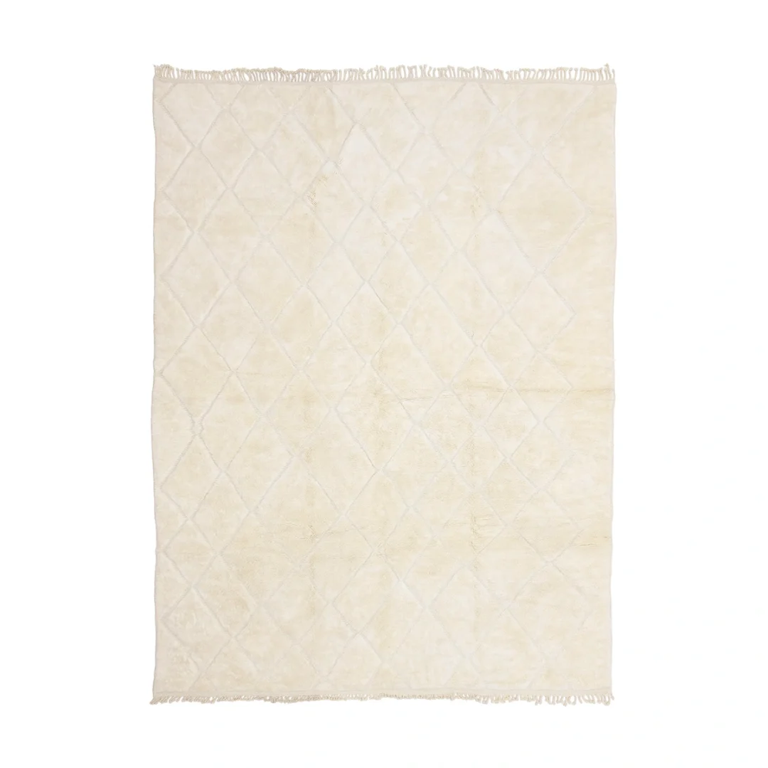 A rectangular cream-colored rug with a subtle diamond pattern and short fringe along the shorter edges is shown on a white background.