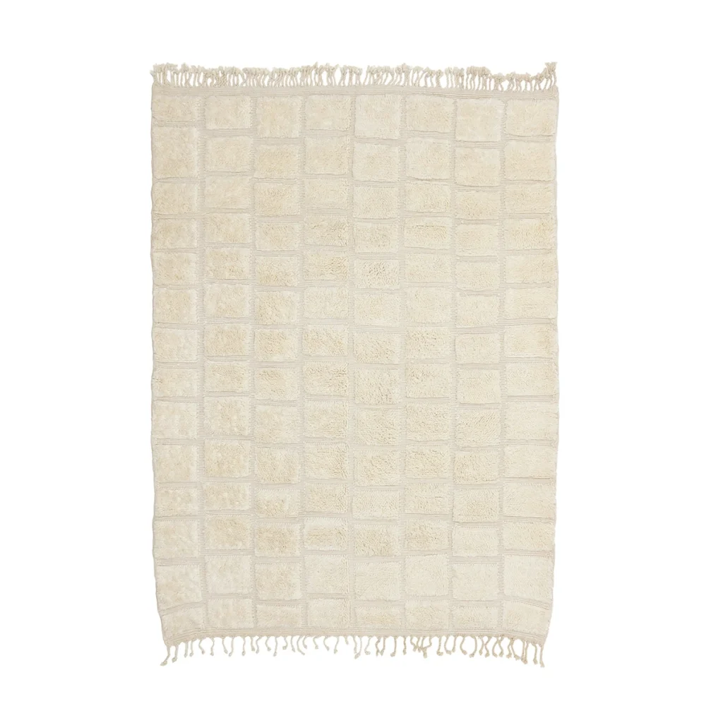 Rectangular cream-colored rug with a grid pattern and short fringes on both shorter edges, displayed on a white background.