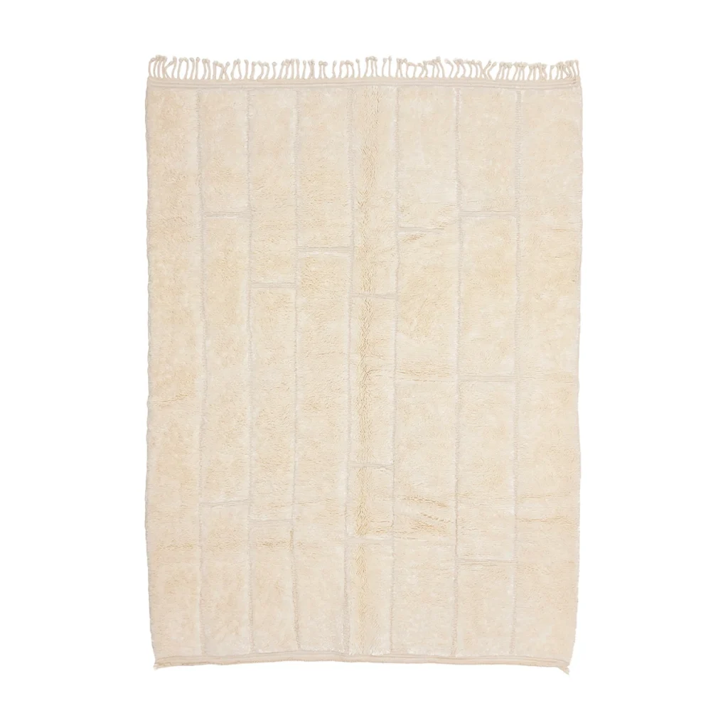 A rectangular cream-colored rug with a subtle grid pattern and fringe on the shorter edges.