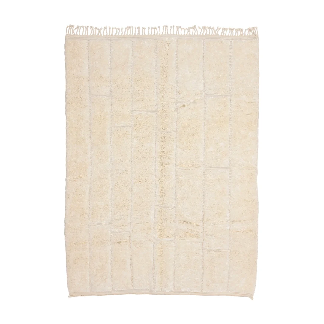 A rectangular cream-colored rug with a subtle grid pattern and fringe on the shorter edges.