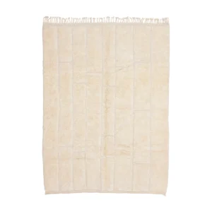 A rectangular cream-colored rug with a subtle grid pattern and fringe on the shorter edges.