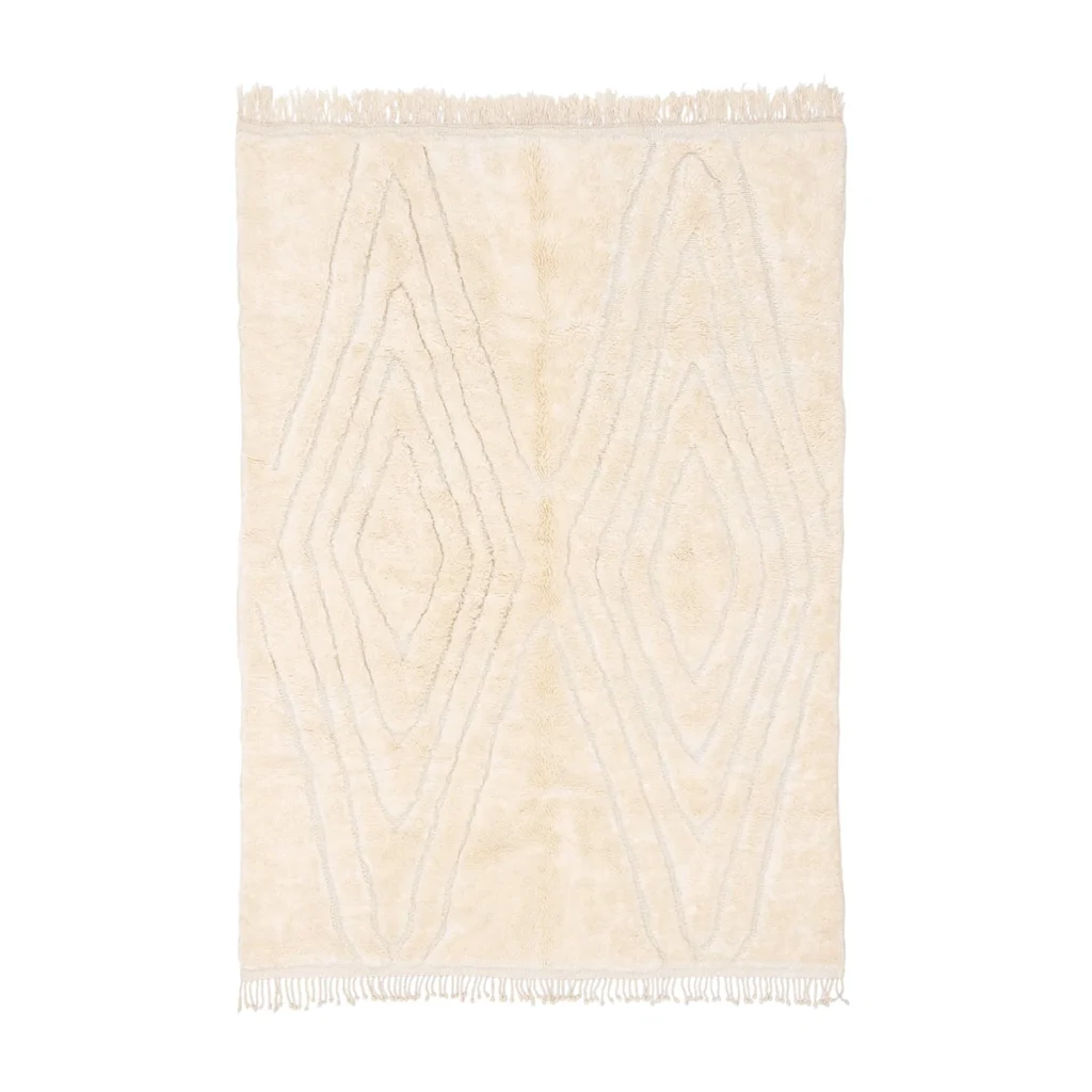 Rectangular cream-colored rug with raised diamond patterns and fringe on the shorter edges, displayed on a white background.