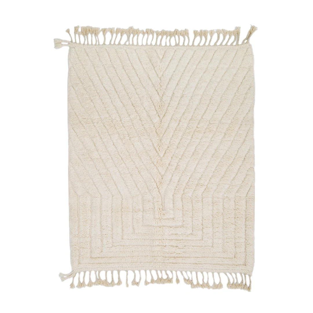 Rectangular cream-colored rug with a raised geometric chevron pattern and fringe on the shorter edges, displayed on a white background.