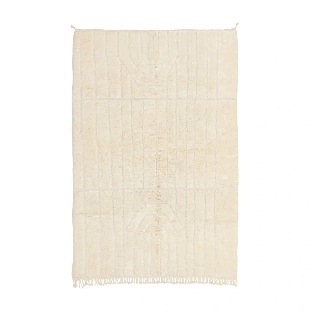 A rectangular, off-white textured rug with subtle geometric patterns and fringe on the bottom edge, displayed on a white background.