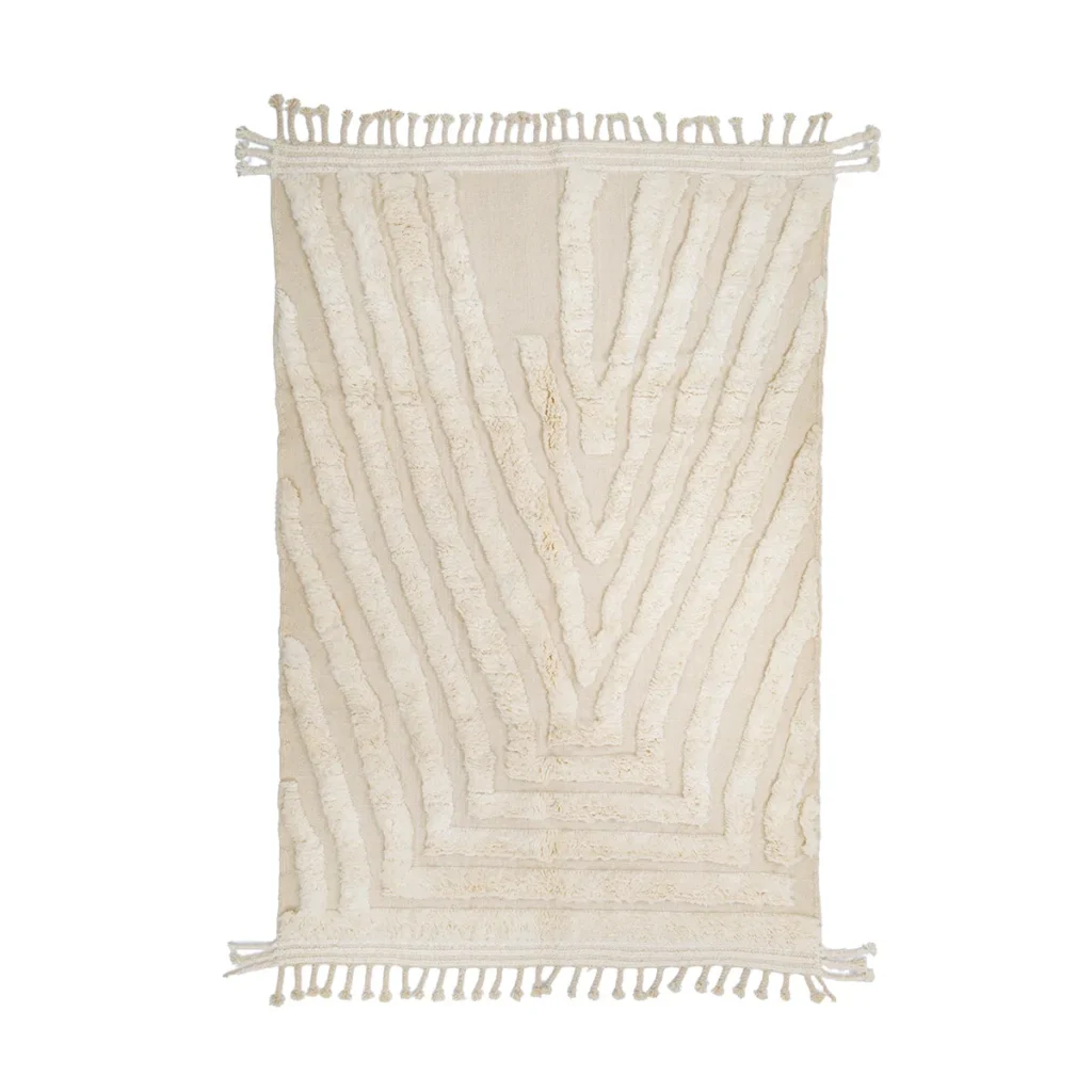 Rectangular cream-colored rug with textured, raised geometric patterns and fringe tassels on the shorter edges.