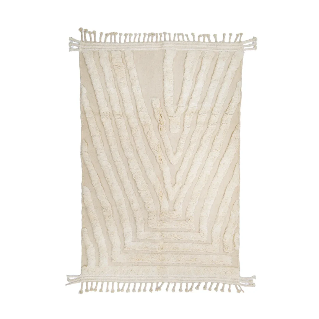 Rectangular cream-colored rug with textured, raised geometric patterns and fringe tassels on the shorter edges.