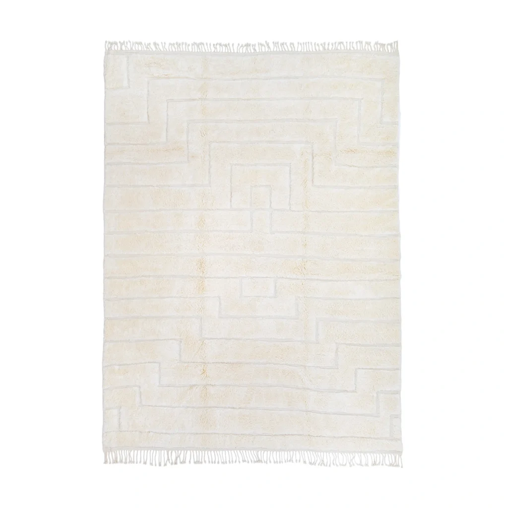 A rectangular cream-colored rug with a subtle geometric pattern and short fringe on both shorter ends, photographed on a white background.