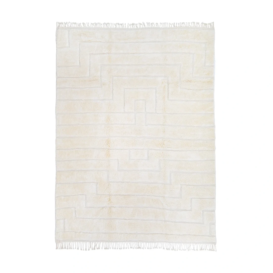 A rectangular cream-colored rug with a subtle geometric pattern and short fringe on both shorter ends, photographed on a white background.