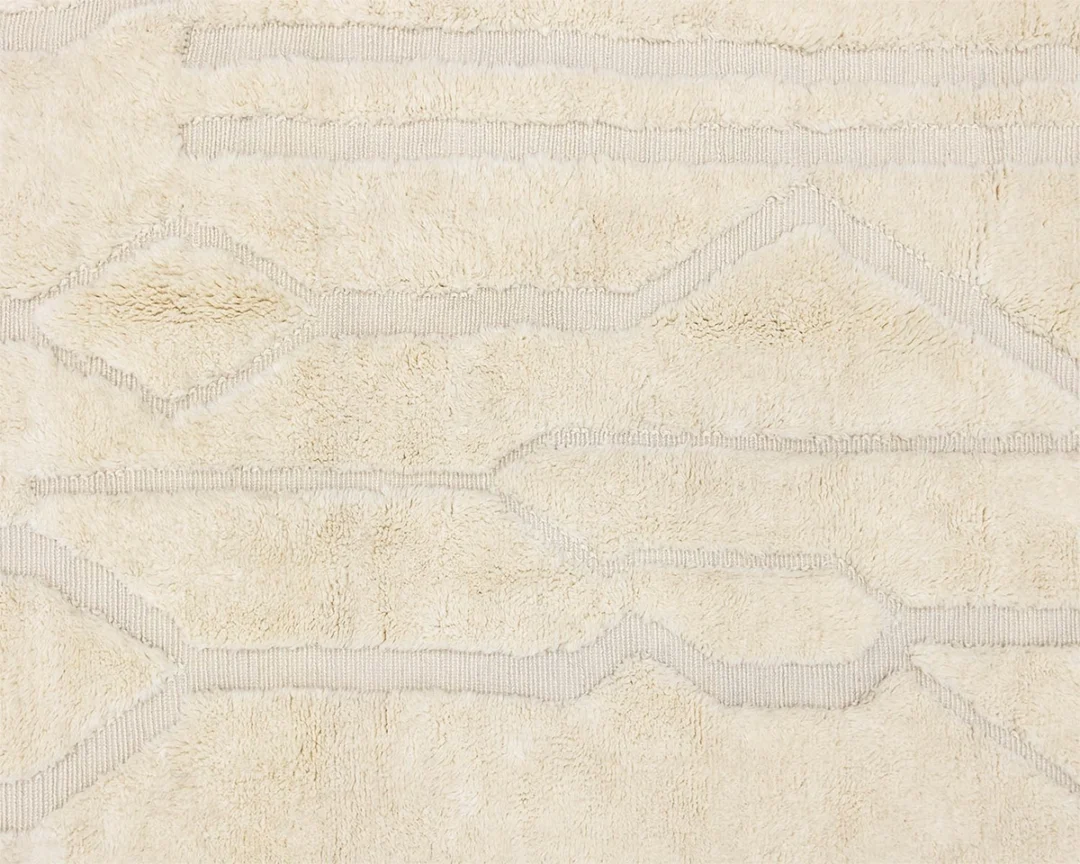 Beige textured carpet with subtle geometric line patterns in a slightly lighter shade.