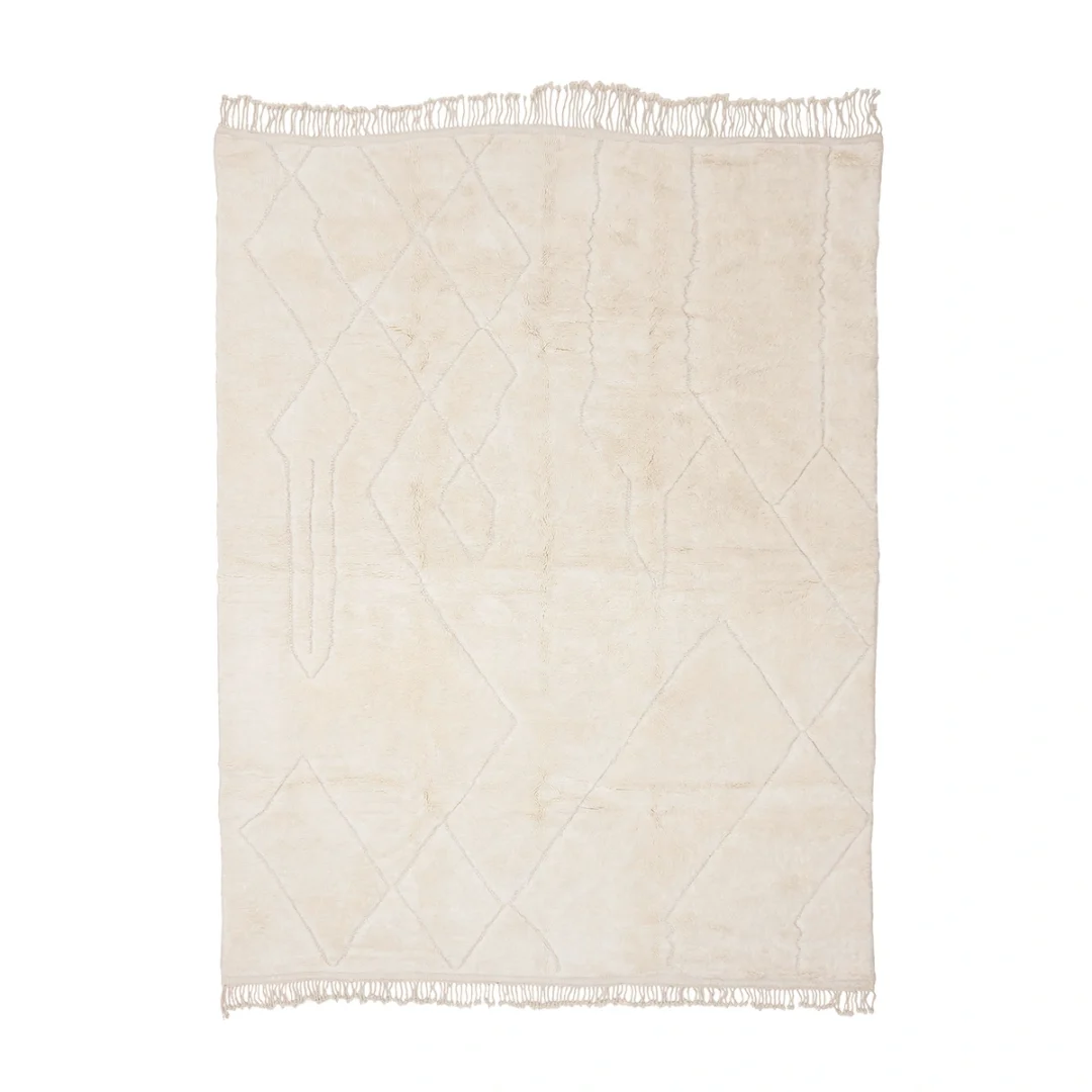 A rectangular off-white rug with subtle geometric line patterns and fringe on the shorter edges, shown against a white background.