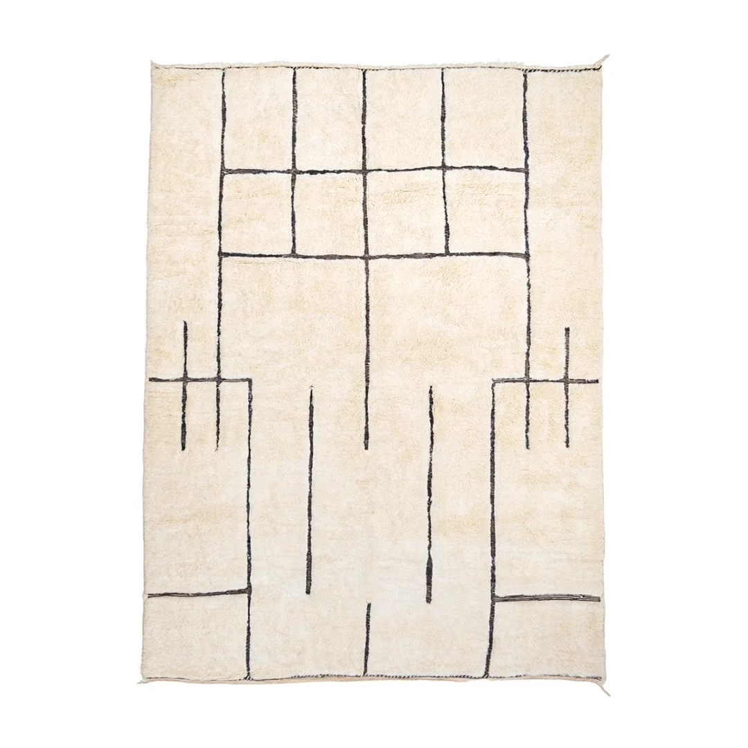 A cream-colored rectangular rug featuring a geometric pattern of irregular black lines forming rectangles and intersecting shapes.