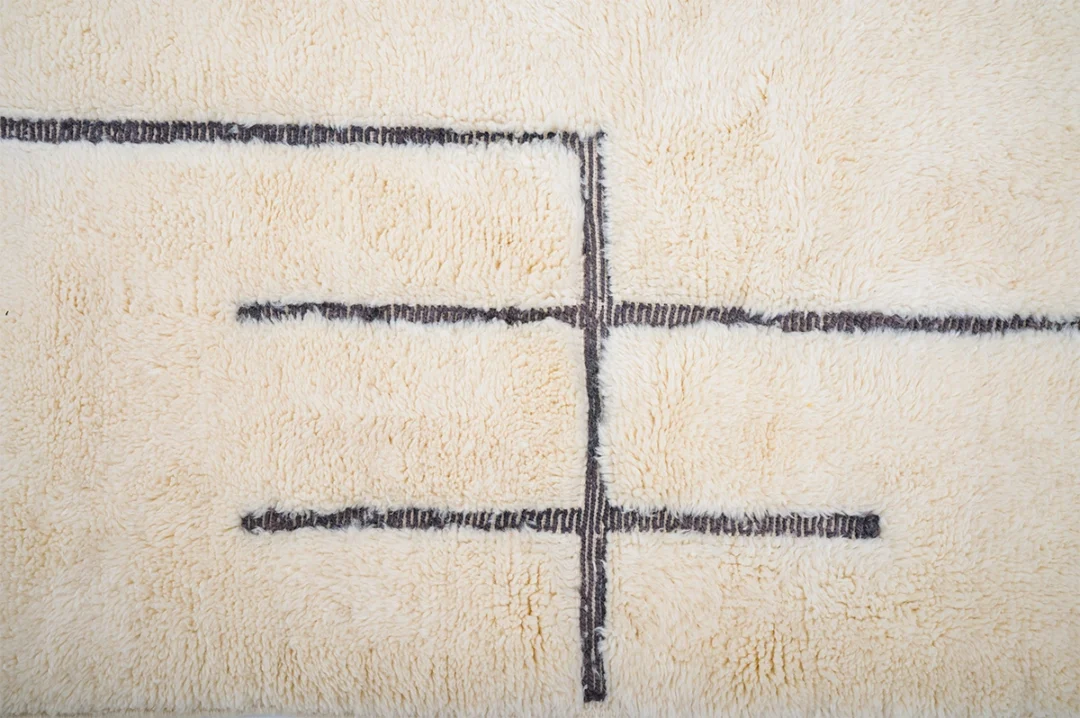 Beige textured rug with three horizontal black lines and one vertical black line crossing through the middle.