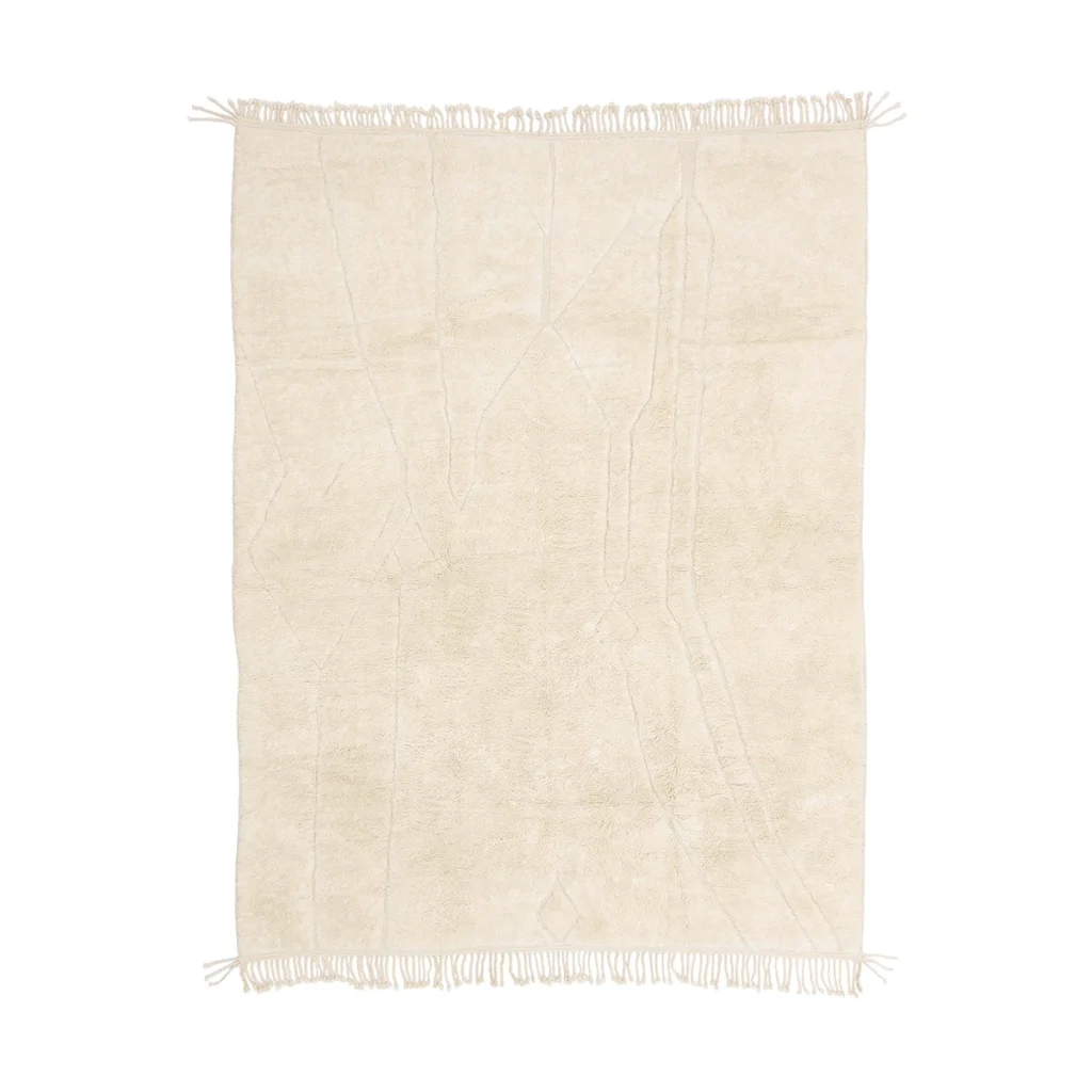 A rectangular, cream-colored rug with subtle abstract lines and fringed edges on the shorter sides.