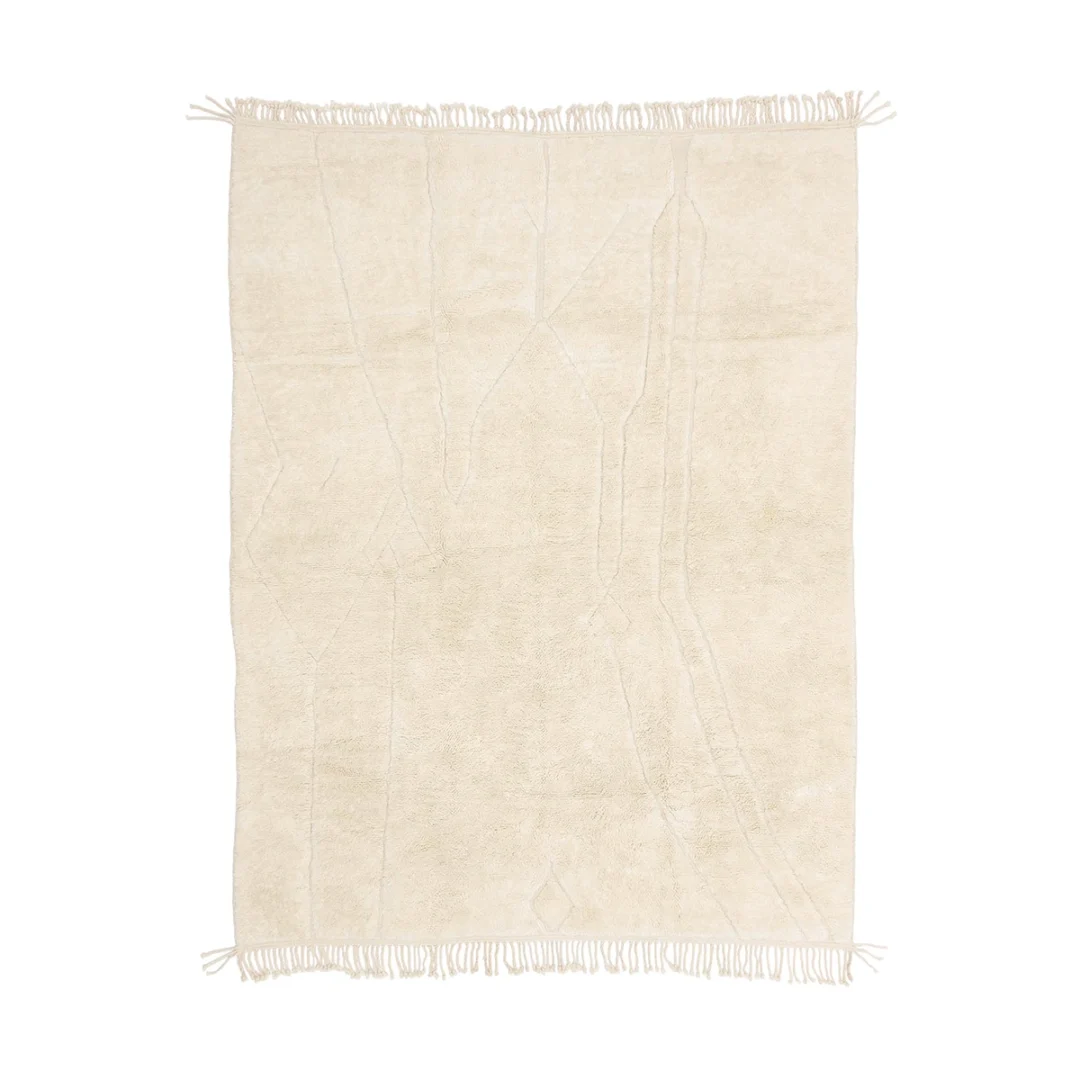A rectangular, cream-colored rug with subtle abstract lines and fringed edges on the shorter sides.