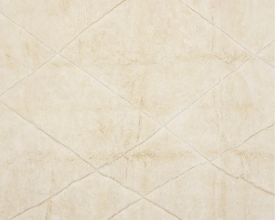 Close-up view of a beige textured surface with a diamond pattern formed by intersecting lines.