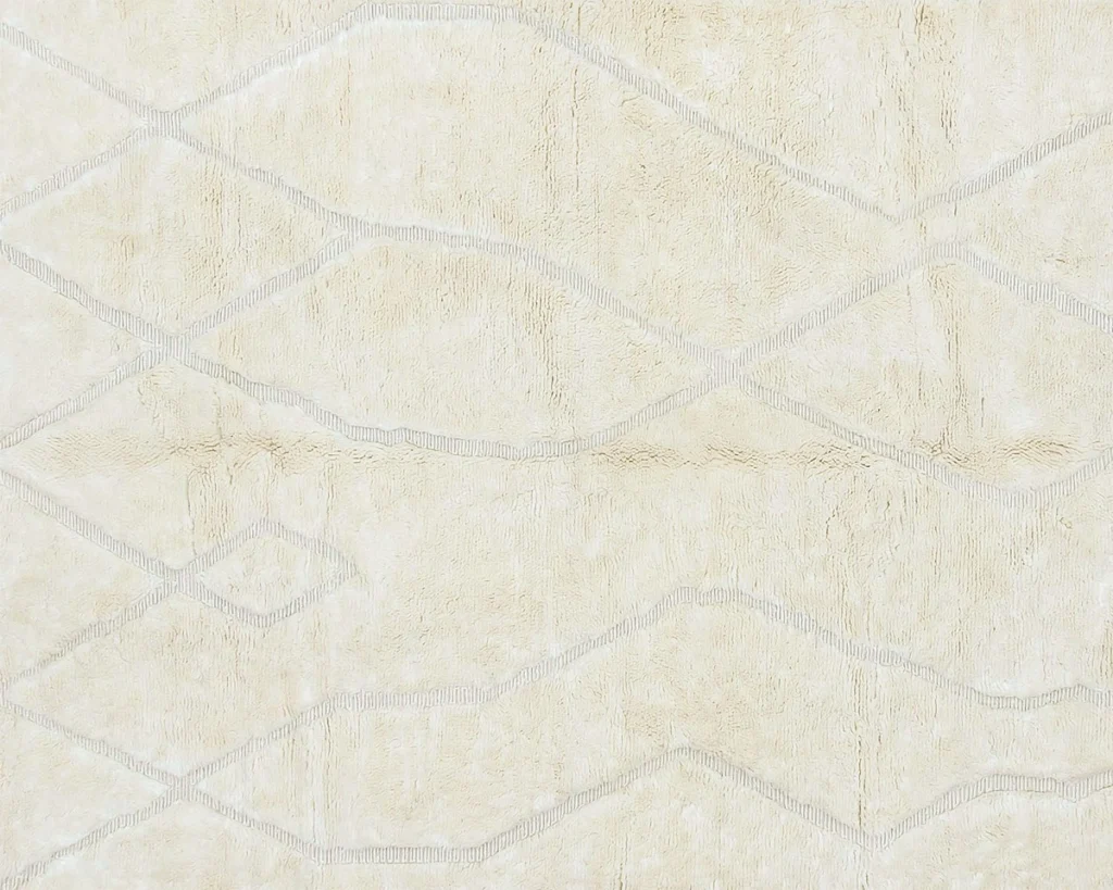 A beige rug with a subtle, irregular diamond pattern outlined in light gray lines.