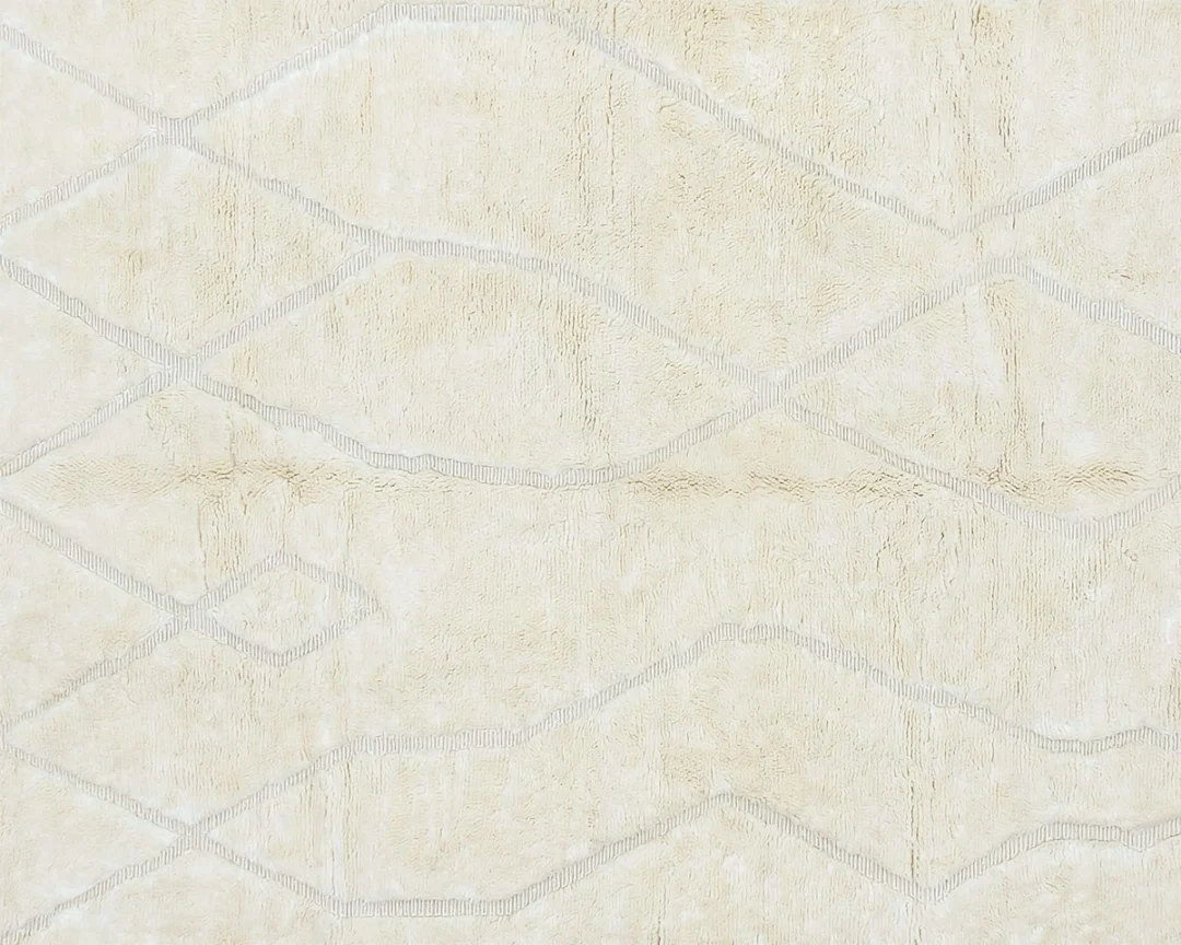 A beige rug with a subtle, irregular diamond pattern outlined in light gray lines.
