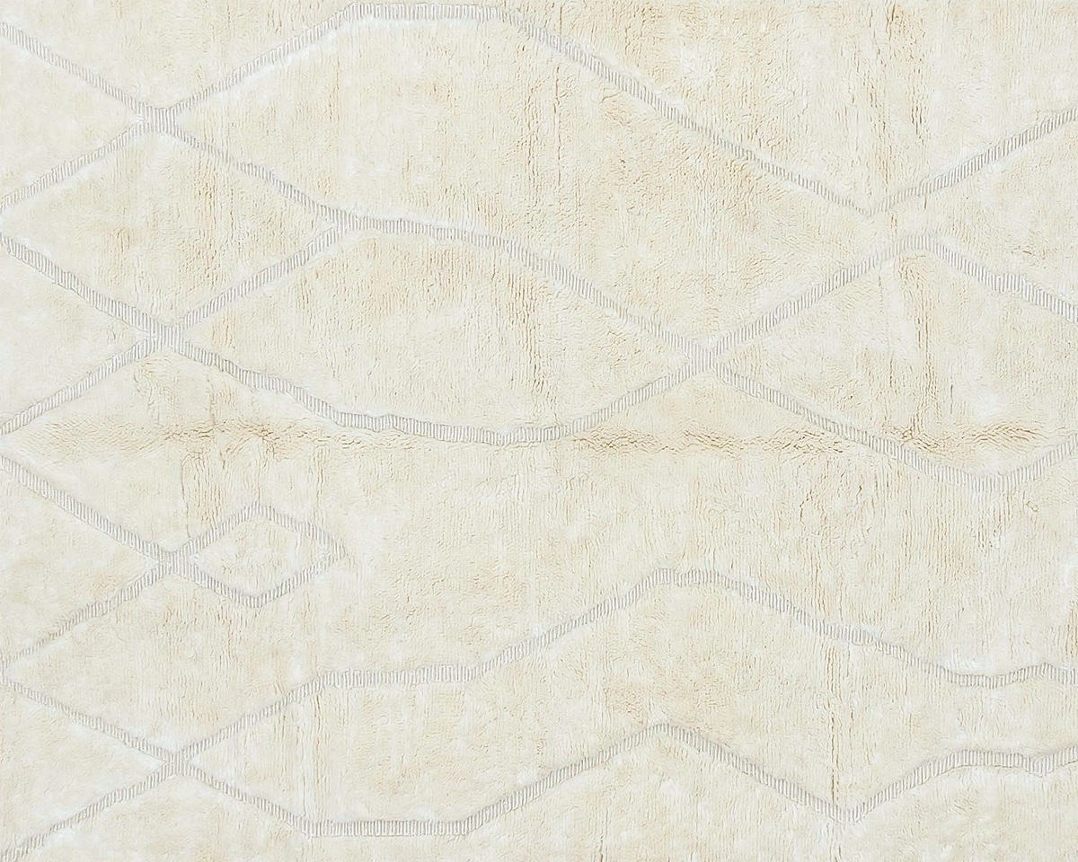 A beige rug with a subtle, irregular diamond pattern outlined in light gray lines.