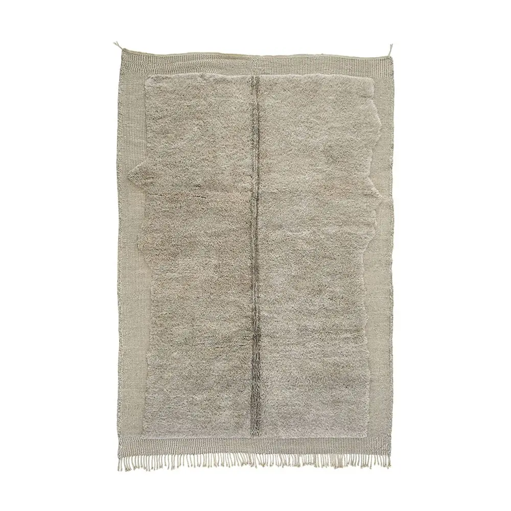 This luxurious hand-knotted rug features a large ivory and beige rectangular design with a textured surface and fringed edges.