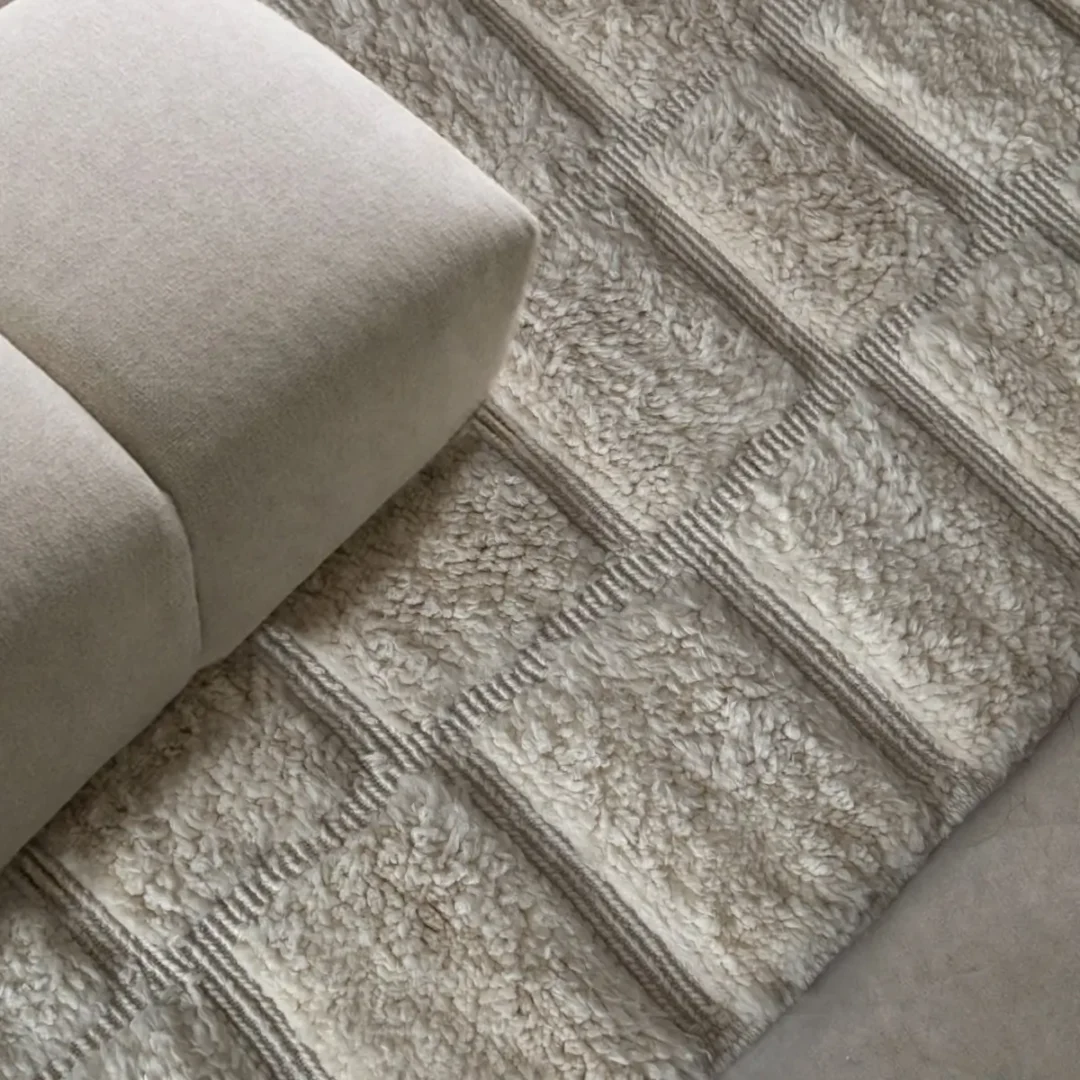 Azele Studio ivory textured wool rug close-up showing hand-knotted checkerboard pattern detail